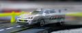 <b>Image 5: Horizontal panoramic image<br>Motion</b><br>I wanted to capture the excitement of Brands Hatch by using rear-sync flash and a longish shutter speed to record the car as a blur followed by a sharp image. I wanted to use the panoramic format to allow some space in front of and behind the car without any distractions above and below it.  I am reasonably pleased with this shot given the technical difficulty in getting the timing right but I could have balanced the ambient light and the flash better to show more of the 'speed' blur behind the car.